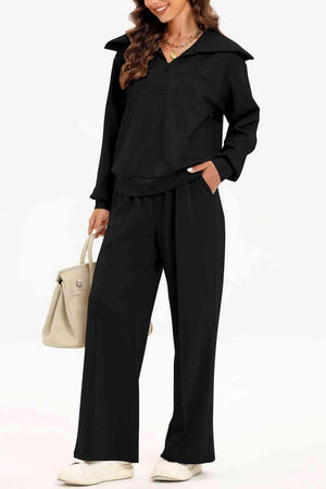 a woman wearing a black jumpsuit and white shoes