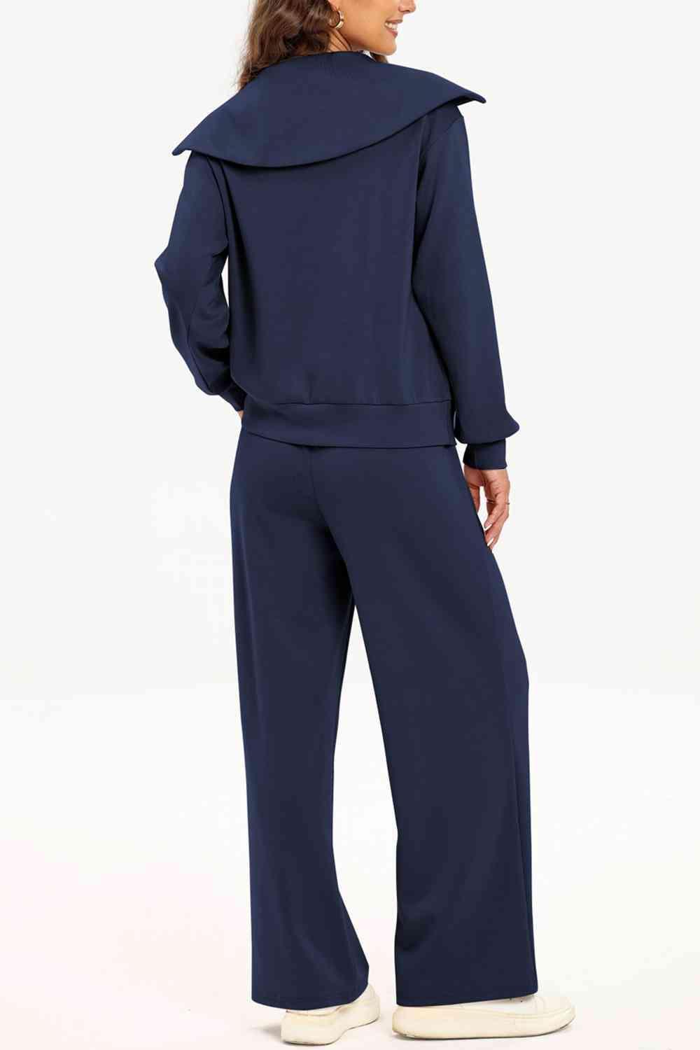 a woman wearing a blue jumpsuit with a hoodie