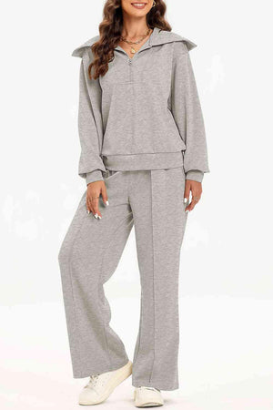 a woman in a grey sweatshirt and pants