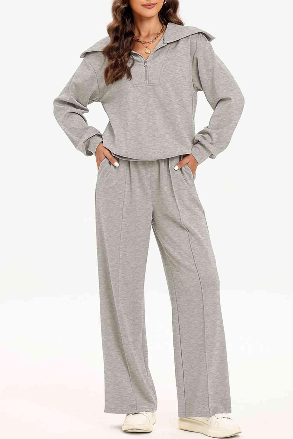 a woman wearing a grey hoodie and pants
