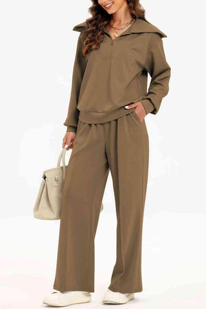 a woman in a brown jumpsuit holding a handbag