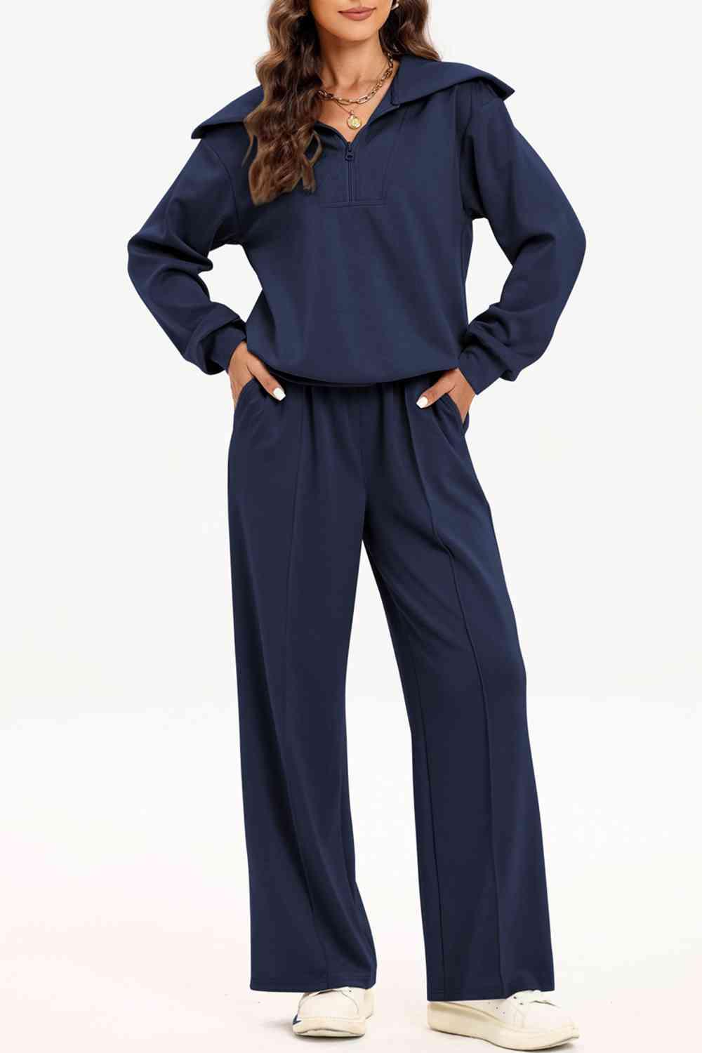 a woman wearing a blue jumpsuit and white sneakers