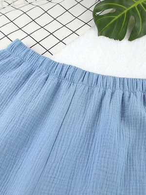 a close up of a blue skirt on a white surface