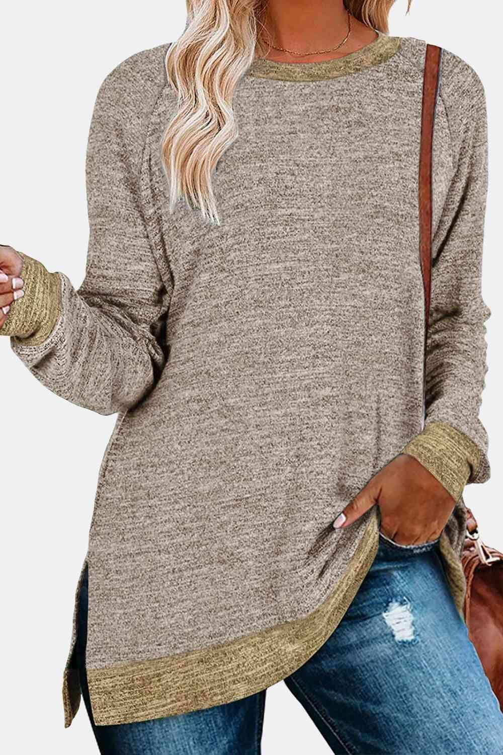 a woman wearing a brown sweater and ripped jeans