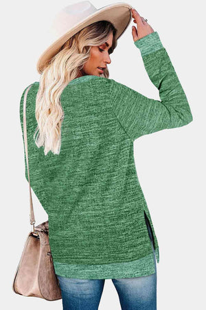 a woman wearing a green sweater and hat