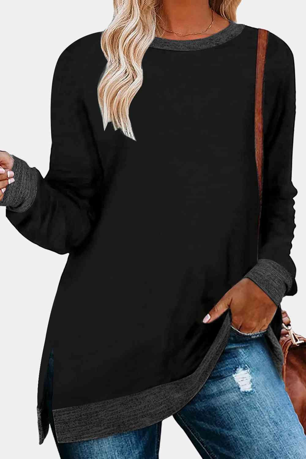 a woman wearing a black sweater and ripped jeans