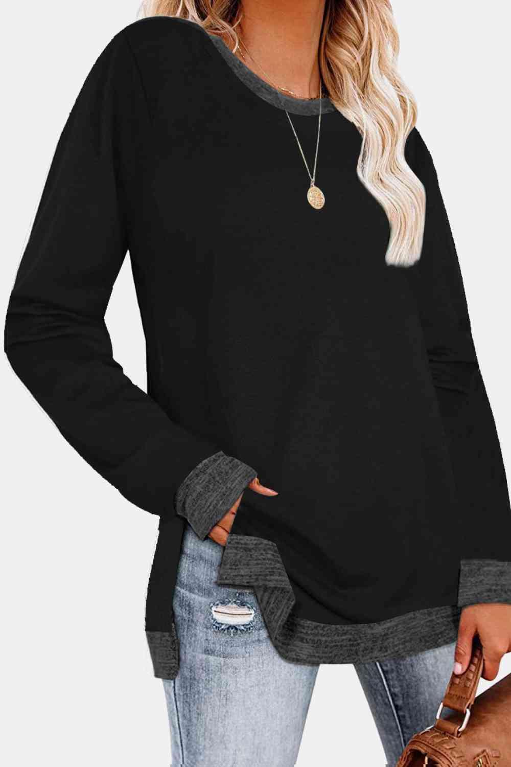 a woman wearing a black sweater and jeans