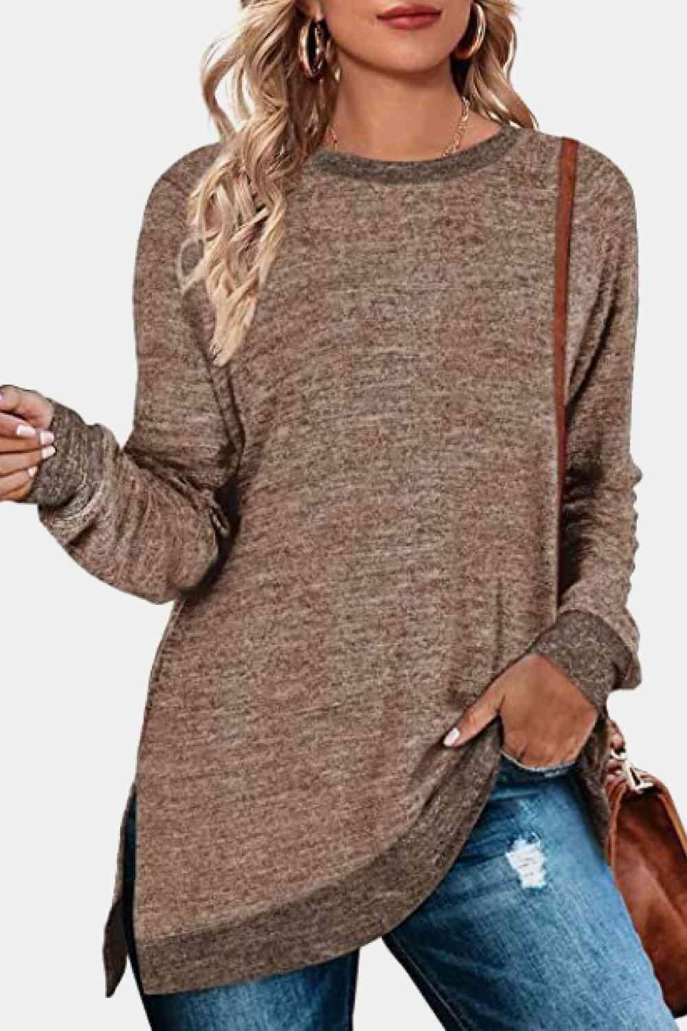 a woman wearing a brown sweater and ripped jeans