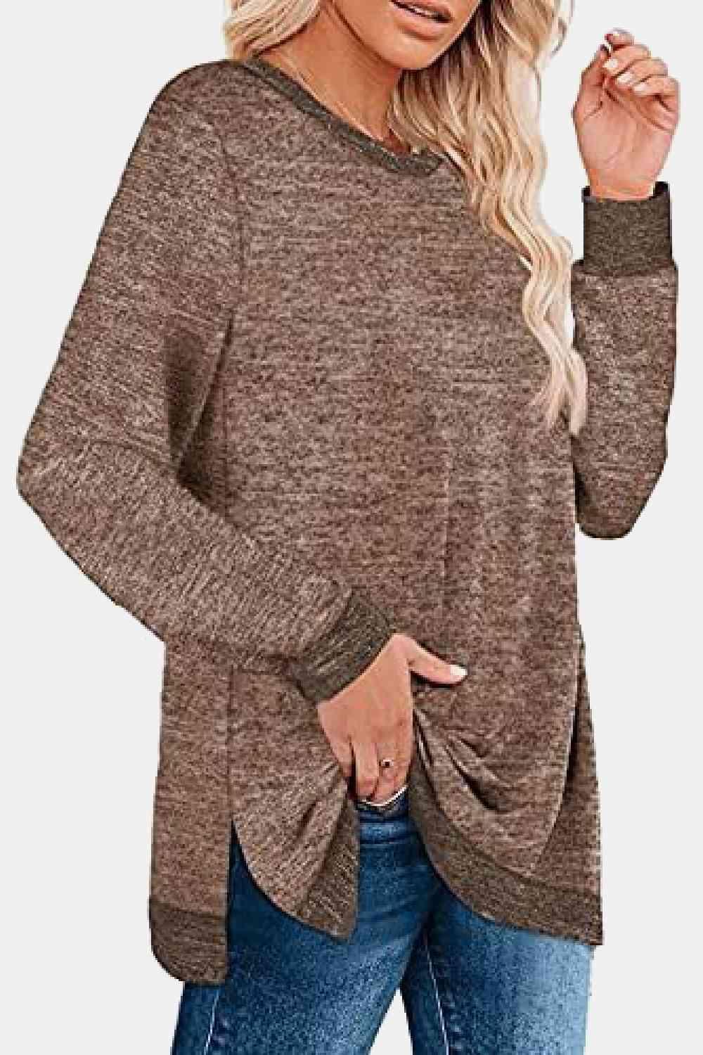 a woman wearing a brown sweater and jeans