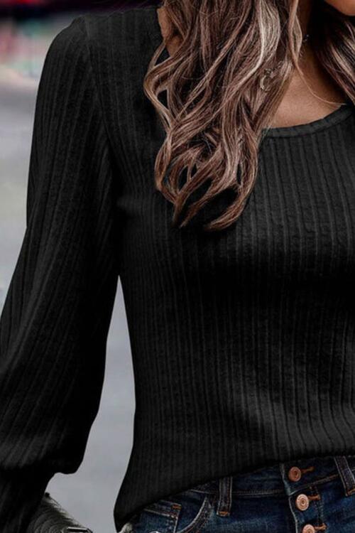 a woman wearing a black sweater and jeans