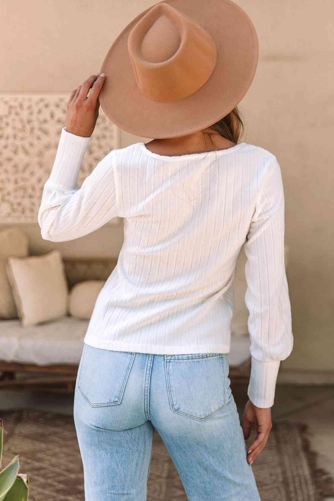 a woman wearing a hat and jeans