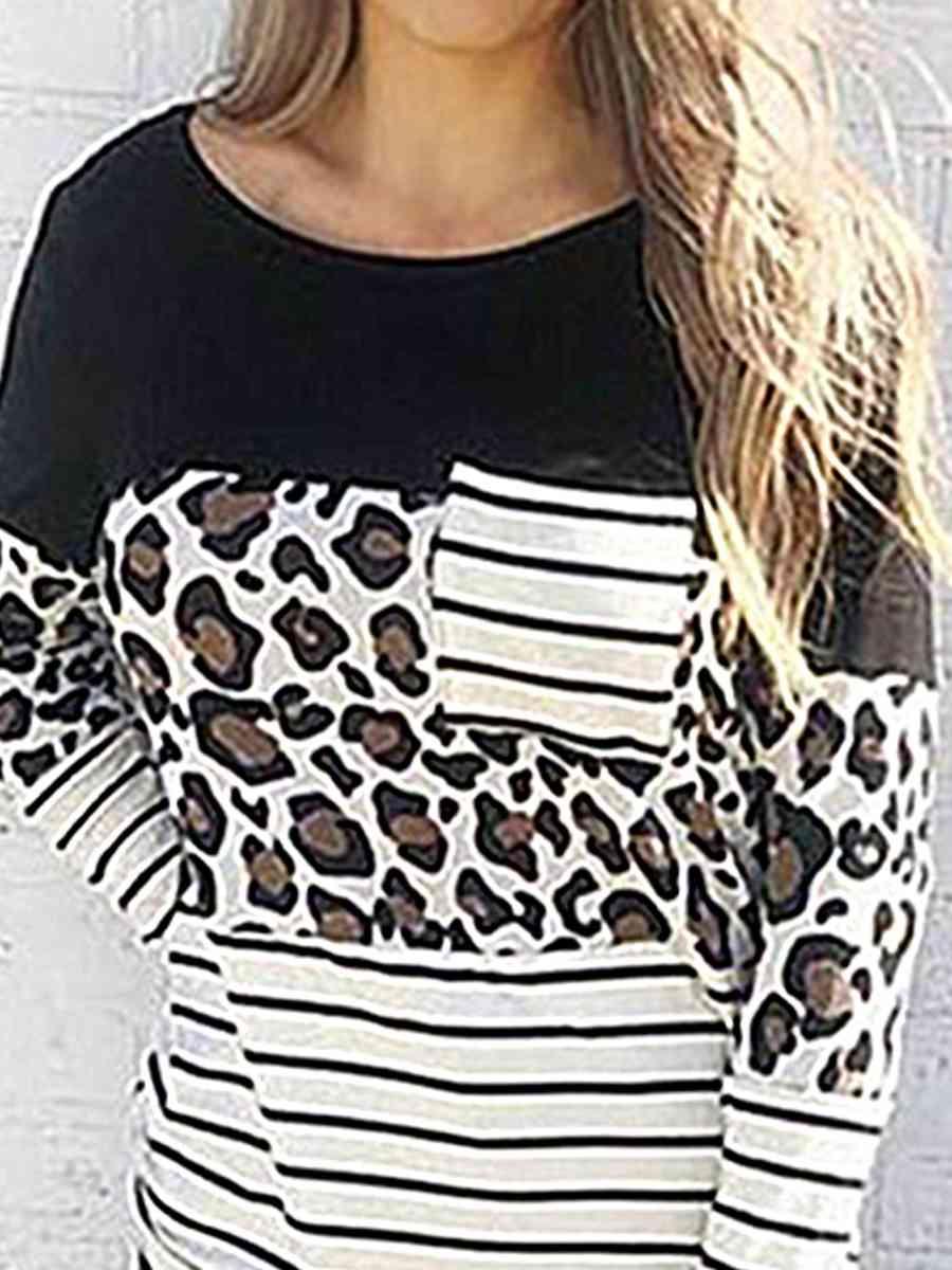 a woman wearing a black and white top with a leopard print on it