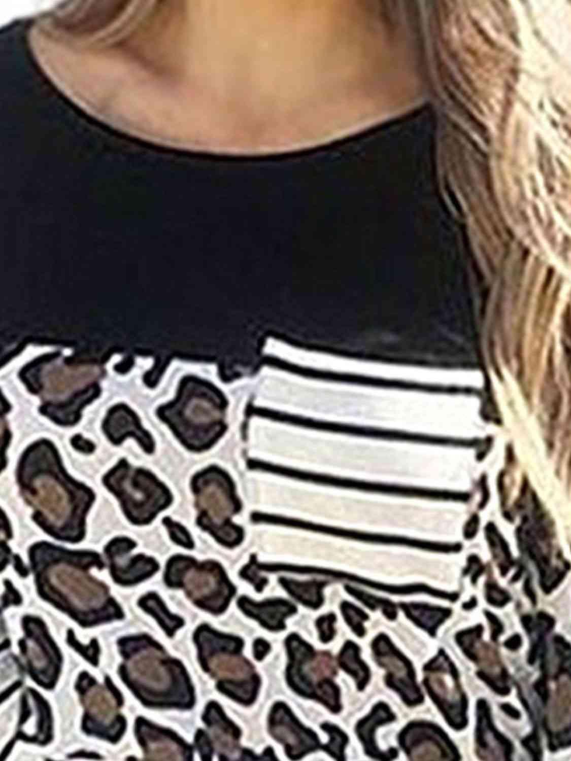 a woman wearing a black and white top with a leopard print