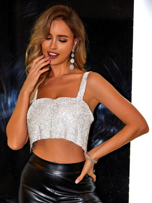 a woman in a white crop top and black leather pants