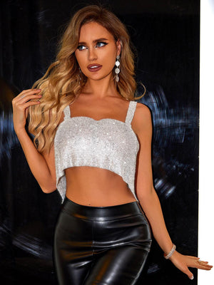 a woman in a white crop top and black leather pants