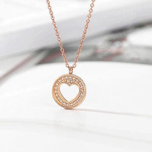 a necklace with a heart on a white surface