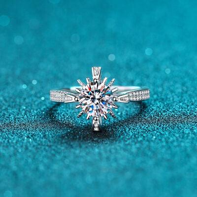 a diamond ring sitting on top of a blue surface