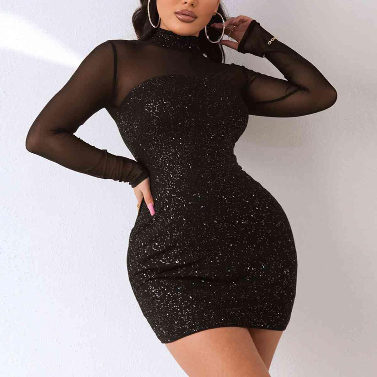 a woman posing in a black dress