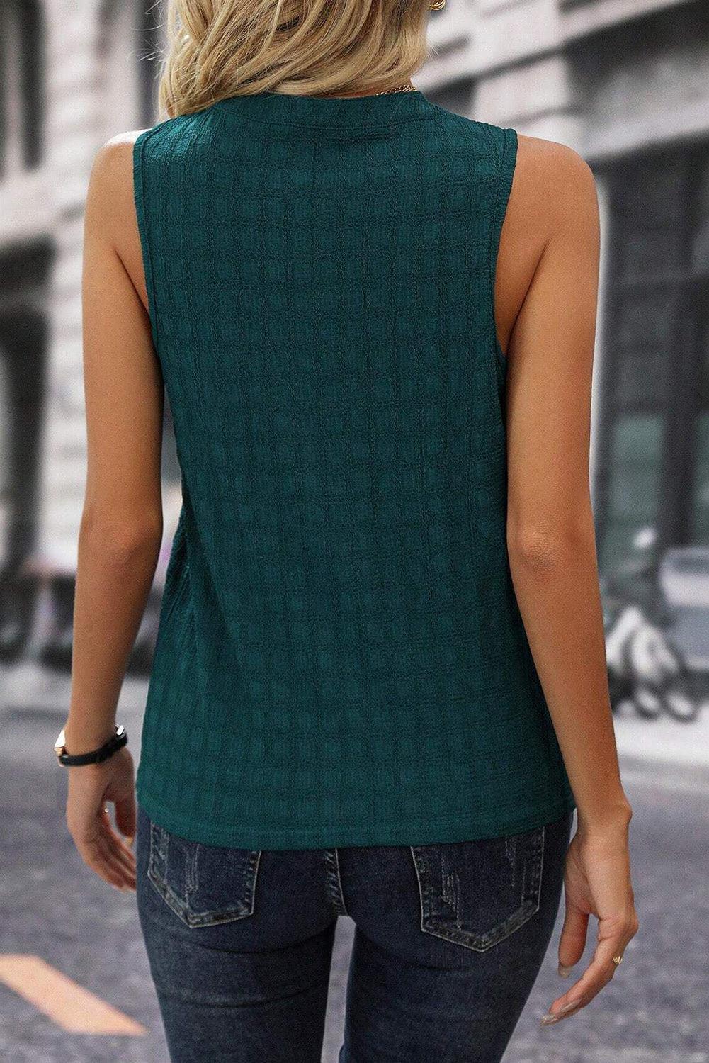 a woman in a green top is walking down the street