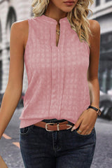 a woman wearing a pink top and jeans