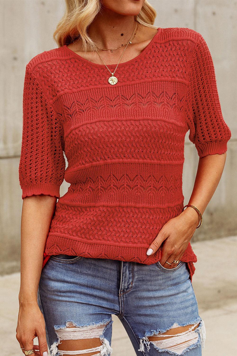 a woman wearing a red sweater and ripped jeans