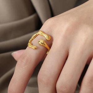 a woman's hand with a gold ring on it