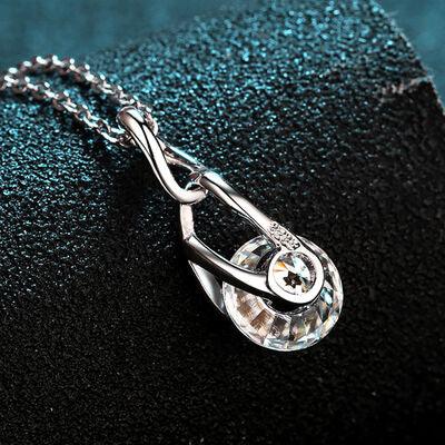 a silver necklace with a crystal tear hanging from it