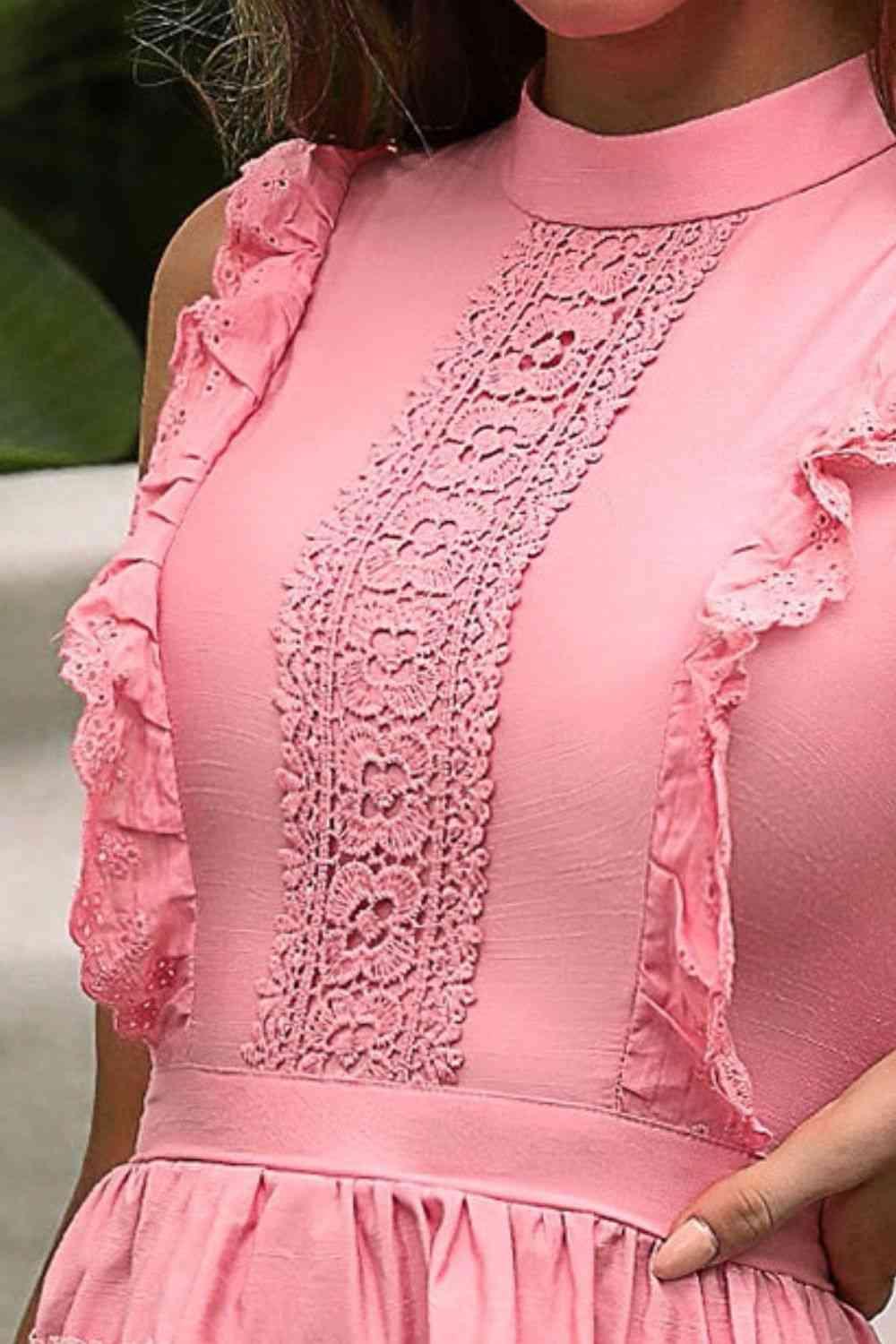 a close up of a woman wearing a pink dress