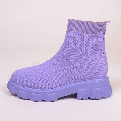 a pair of purple boots on a white background