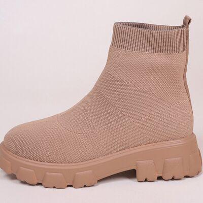 a women's tan boot with a chunky sole