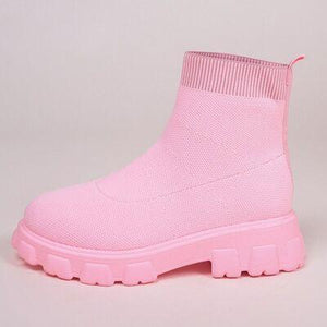 a pair of pink boots on a white background