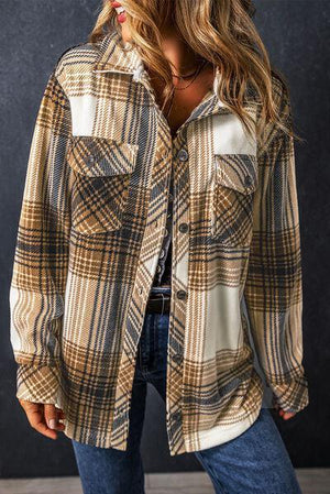 a woman wearing a plaid shirt and jeans