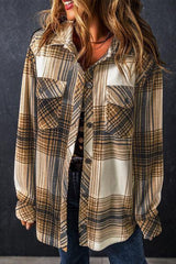 a woman wearing a hat and a plaid shirt