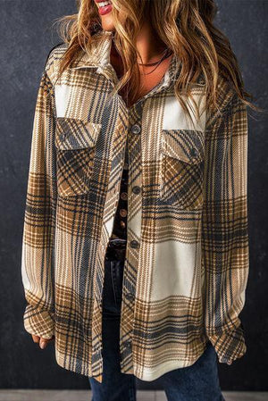 a woman wearing a hat and a plaid shirt