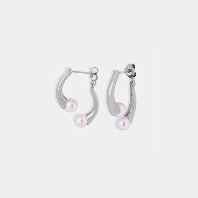 a pair of silver hoop earrings with pearls