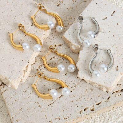 five pairs of earrings with pearls on them