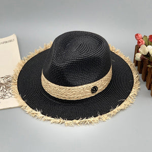 a straw hat sitting next to a book
