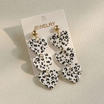 a pair of black and white leopard print earrings
