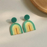 a pair of earrings with a rainbow design