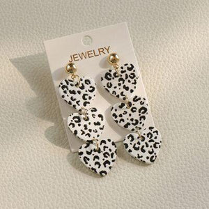 a pair of black and white leopard print earrings