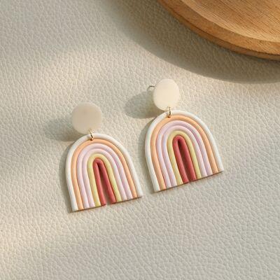 a pair of earrings with a rainbow design