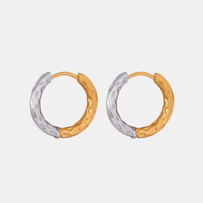 a pair of gold and silver hoop earrings