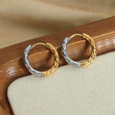 a pair of gold and silver hoop earrings