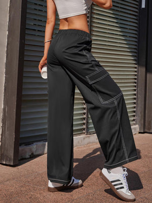 a woman in a crop top and wide legged pants