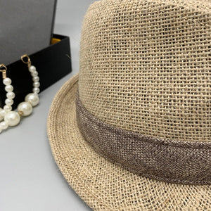 a hat, necklace, and earring sitting on a table