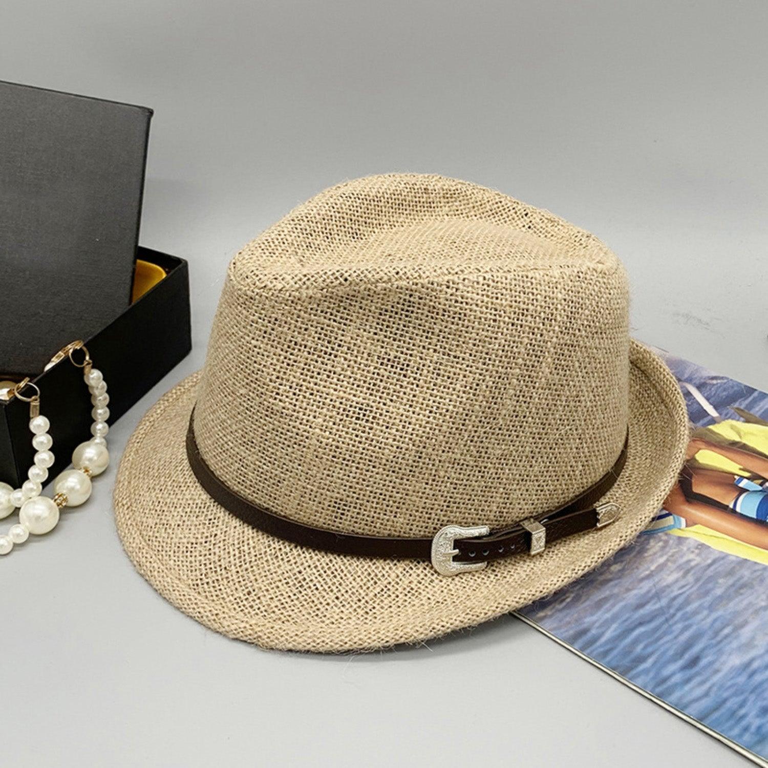 a hat, necklace, and book on a table