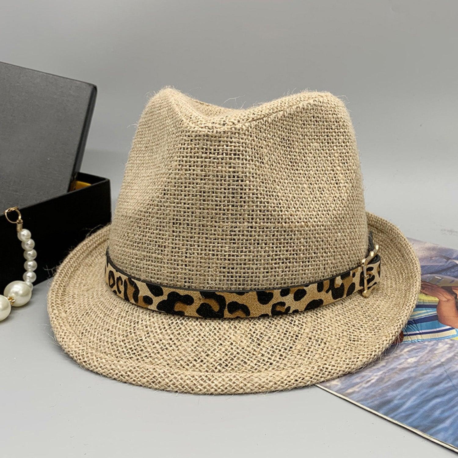 a hat with a leopard print band and a pearl necklace