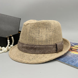 a hat, pearls and a book on a table