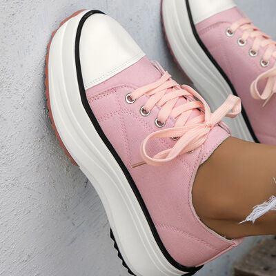 a close up of a person wearing pink sneakers