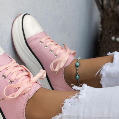 a close up of a person wearing pink sneakers